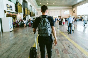 Handsome young man walking in the airport.