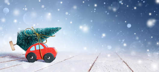 Car Carrying Christmas Tree With Snowfall
