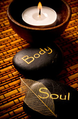 Candle and healing stones with soul, body  like a concept for wellness and mindfulness 