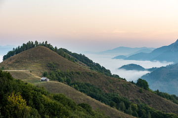 Fototapeta premium Romanian countryside landscape with wooden hut in Apuseni Mountains