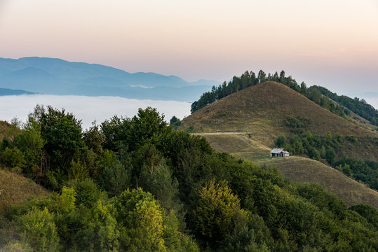 Romanian countryside landscape with wooden hut in Apuseni Mountains