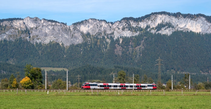 Passenger train goes in the Austrian Alps.