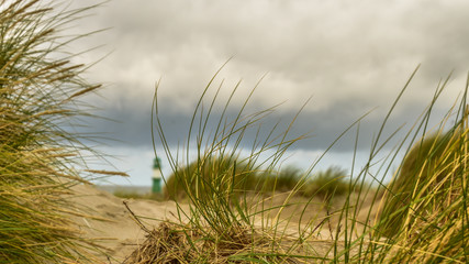 lighthouse behind the dune in warnemuende