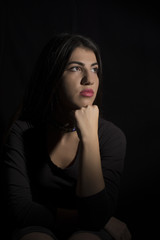 Naklejka premium Young woman ,studio portrait on black background