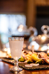Russian vodka is poured into a frozen glass. Evening, gala dinne