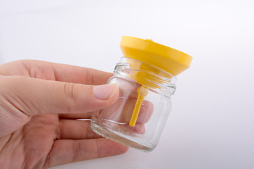 Little empty jar with a funnel in hand