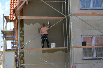 KALININGRAD REGION, RUSSIA.The worker plasters