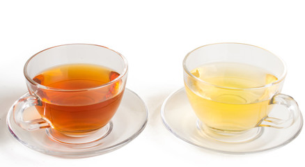 Green and black tea in a glass cup. On white, isolated background.