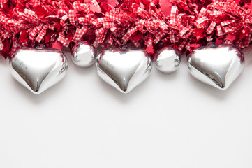 Festive background with heart shaped decorations and white copy