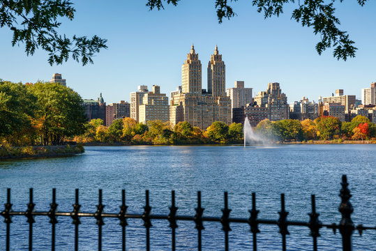 Manhattan Upper West Side with colorful fall foliage and fountain across Jacqueline Kennedy Onassis Reservoir. Central Park West . New York City