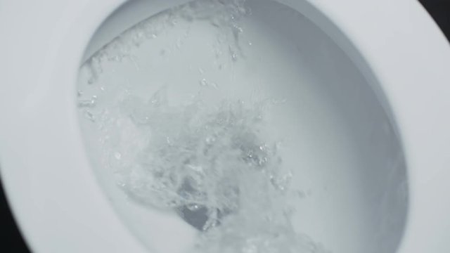 Flushing toilet. Drain the water into white toilet