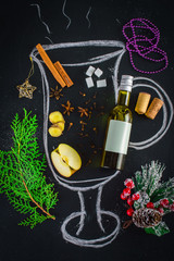 Painted cup of mulled wine. Christmas set. Fruits and spices. On a wooden background.Top view. Flat lay.