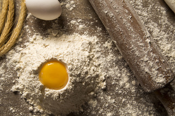 Raw homemade pasta and ingredients for pasta on wooden backgroun