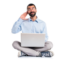 Man with laptop listening something