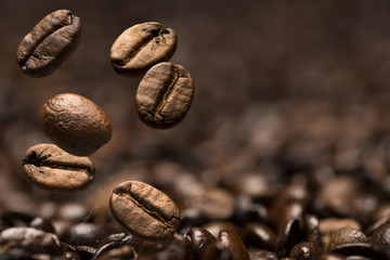 Closeup of coffee beans with focus on one