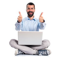 Man with laptop with thumb up