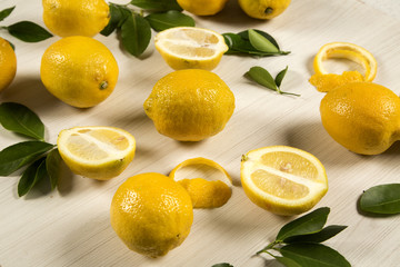 Fresh lemons on white wooden table, top view