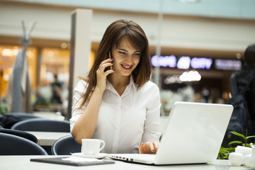 Young beautiful business woman calling by phone