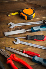 A set of tools for building. On a wooden background.