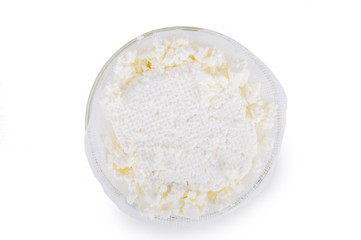 Cottage cheese in a bowl. On white, isolated background.Top view. Flat lay.