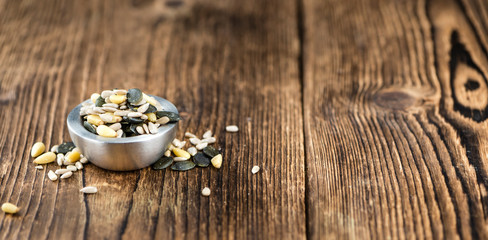 Mixed Seeds on wooden background (selective focus)