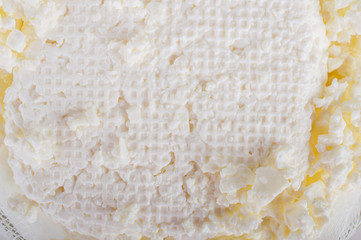 Cottage cheese in a bowl. On white, isolated background.Top view. Flat lay.