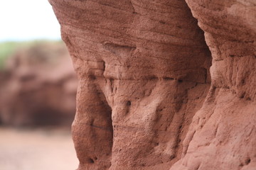 Wind erosion of ruby-red sandstone cliffs and coveted sandy beaches 