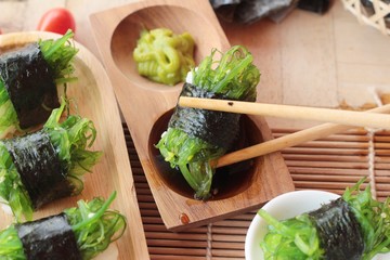 Sushi roll and seaweed salad is delicious.