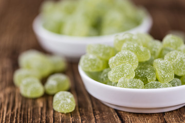 Wooden table with sour gummy candy