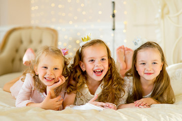 three little princess on the bed © Nichizhenova Elena