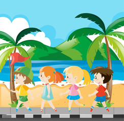 Boys and girls walking along the beach
