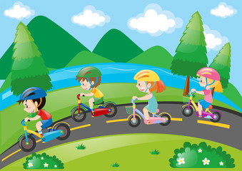 Obraz na płótnie Canvas Children cycling in the park at daytime