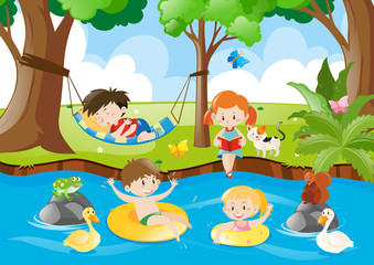 Obraz na płótnie Canvas Children having fun by the river