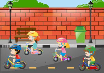 Four children riding bike on the road