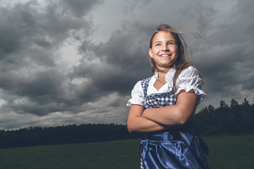 Smiling Girl is waiting for Rain under dark clouds