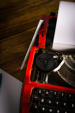 Typewriter. On wooden background.