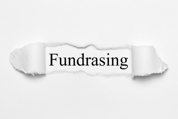 Fundrasing on white torn paper