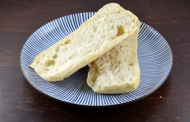 Ciabatta bread roll on a ceramic plate