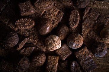 chocolate candy in cocoa on a wooden table