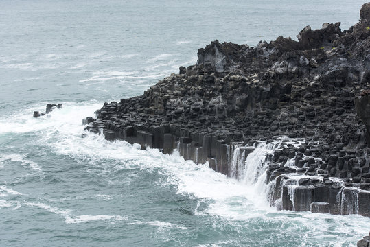 Pacific ocean and black volcanic lava in Jeju Island - South Korea