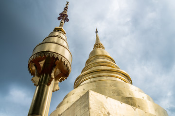 Fototapeta premium The golden pagoda of Wat Phra Singh is a Buddhist temple in Chiang Mai, Northern Thailand.