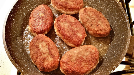 Fresh fried cutlets with oil in a frying pan
