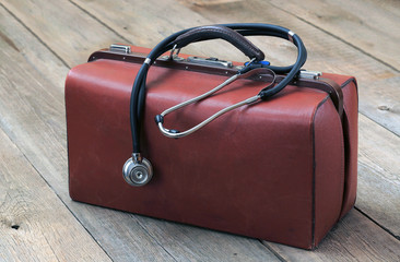 medical bag and stethoscope on the wooden table