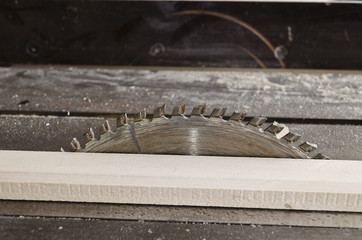 Sawing wooden plate on a workbench