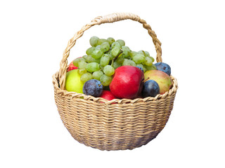Fresh fruits arranged in a wicker basket isolated on white