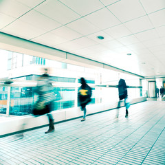 Abstract city background. Blurred image of people moving in tunnel at crowded street. Hong Kong. Blur effect, vintage style toning