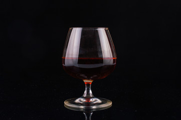 Glass of whiskey on a black background
