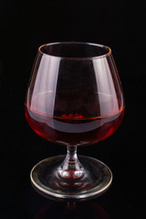 Glass of whiskey on a black background
