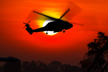 silhouette of helicopter with sunset. © zoneteen