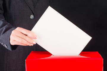 Hand with ballot and box